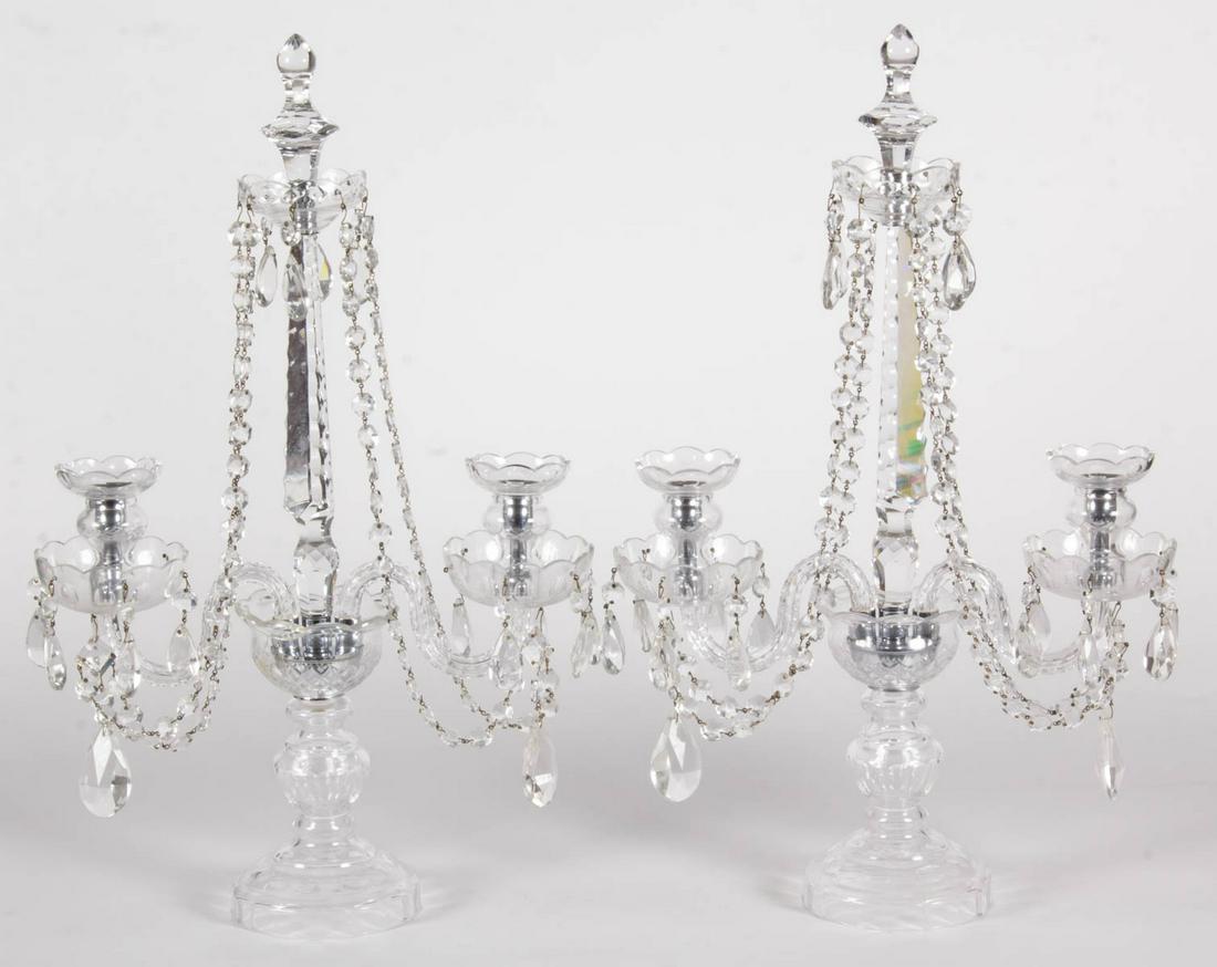CUT CRYSTAL PAIR OF CANDELABRA: CUT CRYSTAL PAIR OF CANDELABRA, colorless, each having a central spire with an upper bobeche and cut-faceted finial, having two supporting arms with flora-form sockets with lower bobeches, all raised 