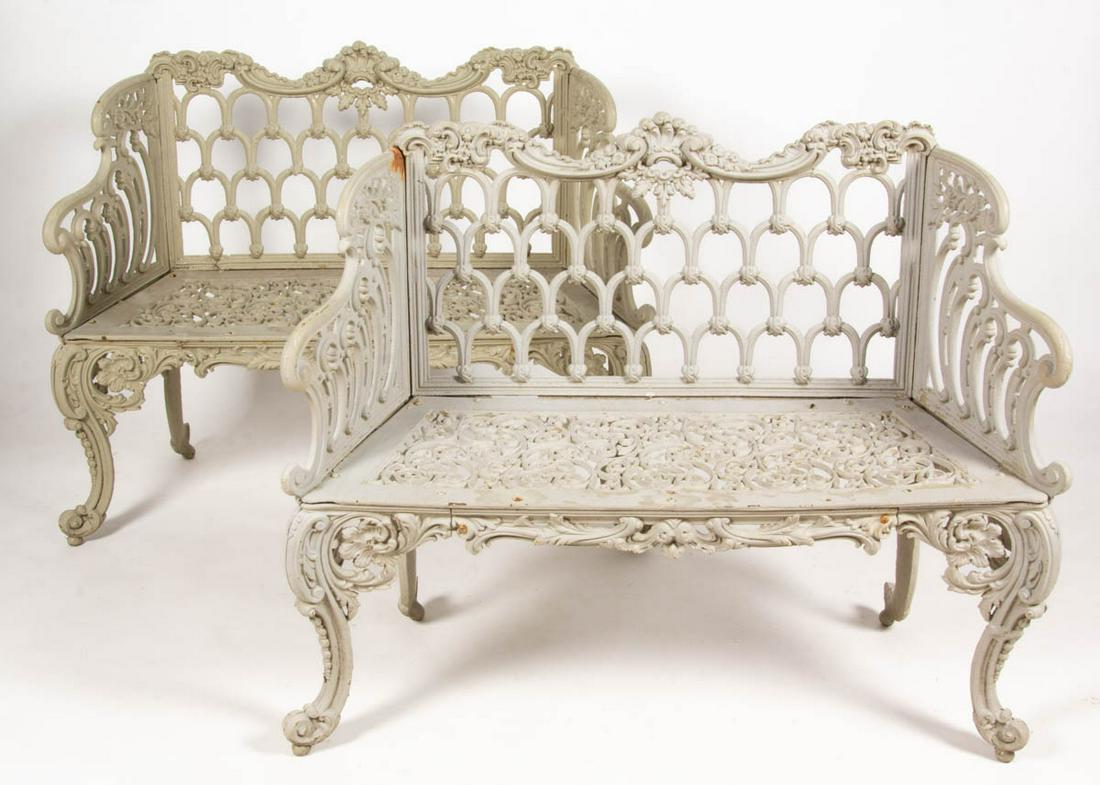AMERICAN ROCOCO REVIVAL CAST-IRON PAIR OF GARDEN BENCHES / SETTEES: AMERICAN ROCOCO REVIVAL CAST-IRON PAIR OF GARDEN BENCHES / SETTEES, cast in seven sections, each high-back form with repeated "horseshoes", scrolling arms, and pierced seat, raised on cabriole-style l