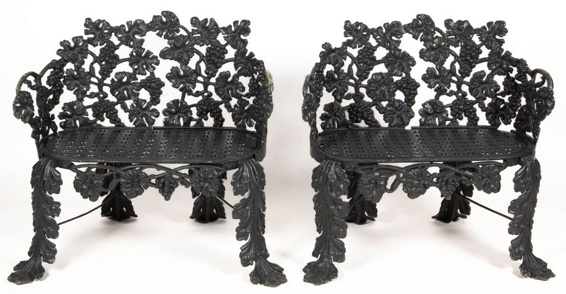 AMERICAN NATURALISTIC CAST-IRON PAIR OF GARDEN BENCHES / SETTEES: AMERICAN NATURALISTIC CAST-IRON PAIR OF GARDEN BENCHES / SETTEES, cast in ten sections, each arched back in an intricate grapevine pattern continuing to half arms above a pierced seat, raised on acant