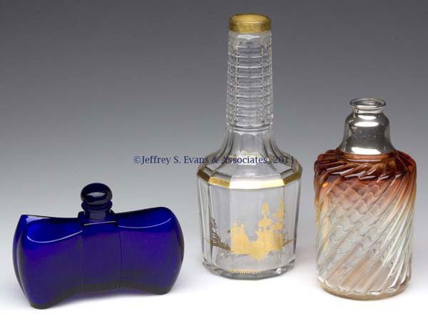 BACCARAT COMMERCIAL FRAGRANCE BOTTLES, LOT OF THREE: BACCARAT COMMERCIAL FRAGRANCE BOTTLES, LOT OF THREE, comprising a cobalt blue Guerlain "Coque d'Or" example, stopper and bottle with matching numbers; a Houbigant cut glass example with gilt transfer