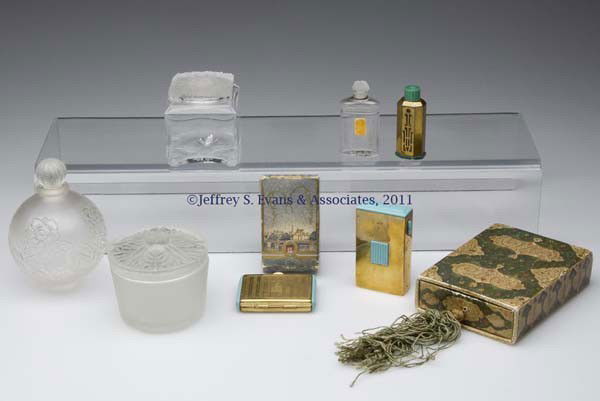 COTY COMMERCIAL FRAGRANCE BOTTLES AND OTHER ARTICLE: COTY COMMERCIAL FRAGRANCE BOTTLES AND OTHER ARTICLES, LOT OF EIGHT, colorless and frosted finish, comprising a "A Suma" spherical floral bottle, lacking stand, with matching numbers on stopper and bas