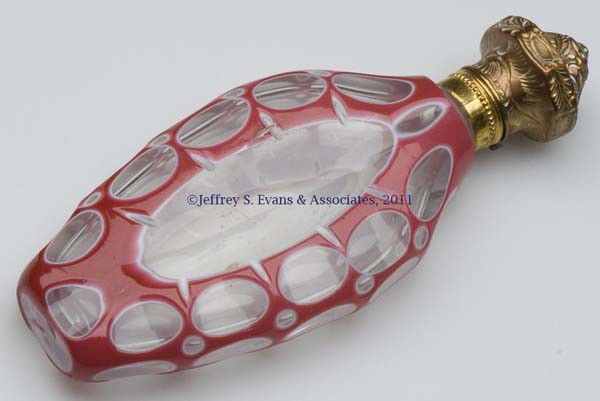 CUT DOUBLE OVERLAY SCENT BOTTLE: CUT DOUBLE OVERLAY SCENT BOTTLE, rose to white to colorless, hinged gilt-metal fittings, polished base, lacking inner stopper. Second half 19th century. 4 1/8" HOA. Provenance: From the Sylvia Applebe