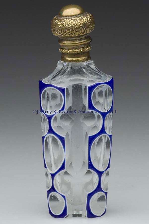 CUT DOUBLE OVERLAY SCENT BOTTLE: CUT DOUBLE OVERLAY SCENT BOTTLE, blue to white to colorless, hinged gilt-metal fittings, inner stopper present, polished base. Second half 19th century. 3 3/4" HOA. Provenance: From the Sylvia Applebe