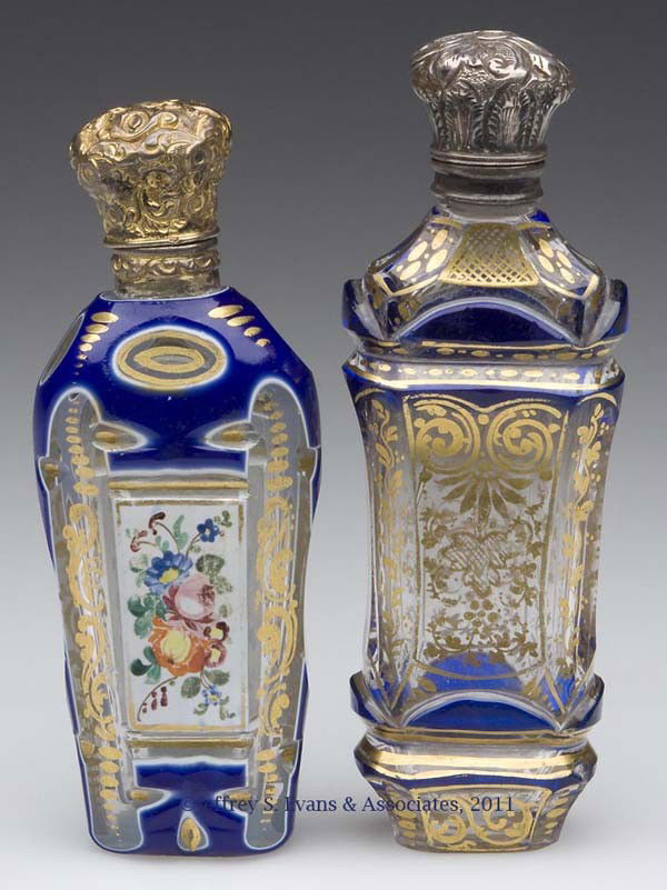 CUT OVERLAY SCENT BOTTLES, LOT OF TWO: CUT OVERLAY SCENT BOTTLES, LOT OF TWO, comprising a blue to white to colorless example with polychrome floral and gilt decoration, gilt-metal fittings and inappropriate inner stopper; and a blue to co