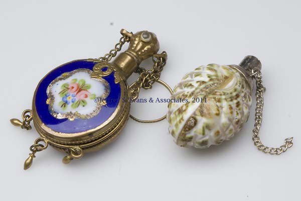 PORCELAIN SCENT BOTTLES, LOT OF TWO: PORCELAIN SCENT BOTTLES, LOT OF TWO, comprising a polychrome and gilt floral decorated example, gilt-metal fittings with a finger/chatelaine ring, and a stopper made to hold a Stanhope, now missing; a