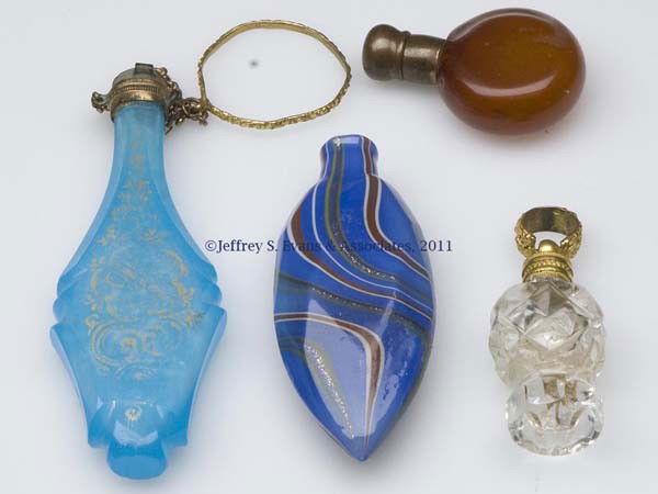MINIATURE SCENT BOTTLES, LOT OF FOUR: MINIATURE SCENT BOTTLES, LOT OF FOUR, various colors, comprising a translucent blue cut and gilded example with finger/chatelaine ring, lacking stopper, a colorless cut glass example with small hangin