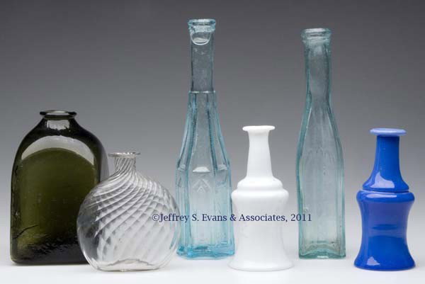 SIX ASSORTED BLOWN BOTTLES: SIX ASSORTED BLOWN BOTTLES, comprising a colorless pocket flask with 20 swirled ribs, two aqua pepper sauce bottles, two opaque cruets, and an olive green snuff or ink. 19th century. 4" to 8 3/4" H. P