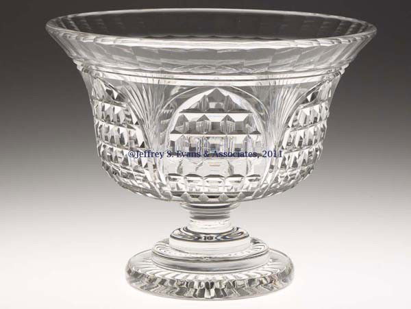 CUT BLOCKED ARCH AND RAY BOWL ON FOOT: CUT BLOCKED ARCH AND RAY BOWL ON FOOT, colorless, deep bowl with panel-cut rim, raised on a short stem and three-step circular star-cut foot. United States or Europe. 1880-1920. 6 1/2" H, 8 1/4" D rim
