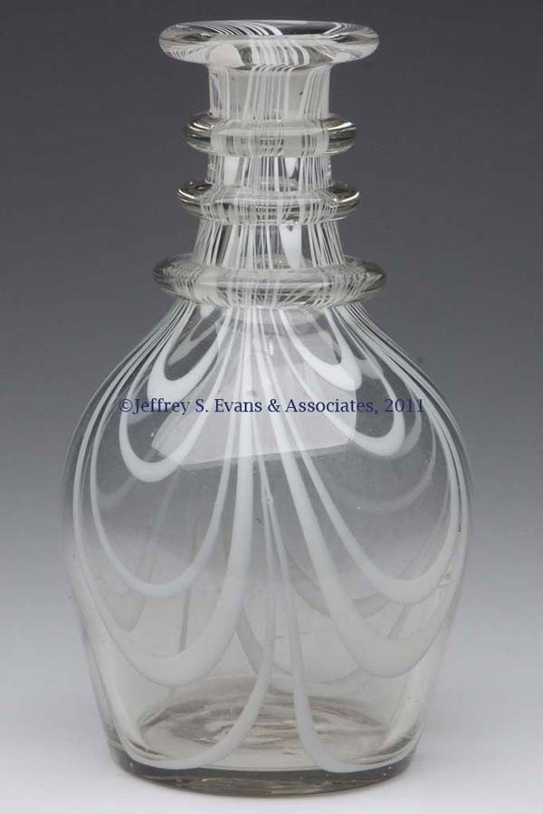 FREE-BLOWN MARBRIE LOOP DECORATED QUART DECANTER: FREE-BLOWN MARBRIE LOOP DECORATED QUART DECANTER, gray-tinted colorless with opal loopings, shouldered form with three applied neck rings and a flanged mouth, rough pontil mark, lacking stopper. South
