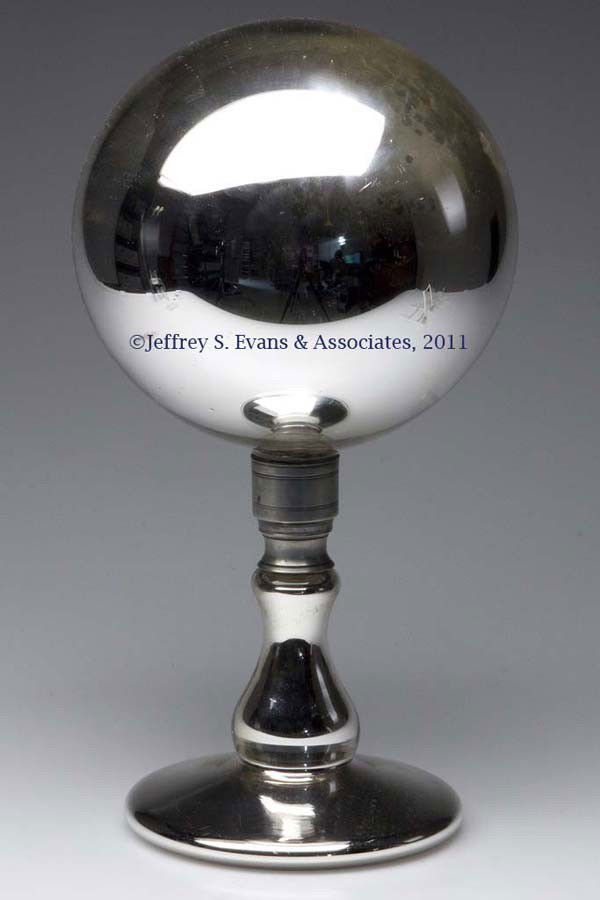 SILVERED / MERCURY GLASS GLOBE ON STAND: SILVERED / MERCURY GLASS GLOBE ON STAND, in two sections, each retaining its original Britannia screw connector, polished pontil mark under base. Probably United States, possibly New England Glass Co.