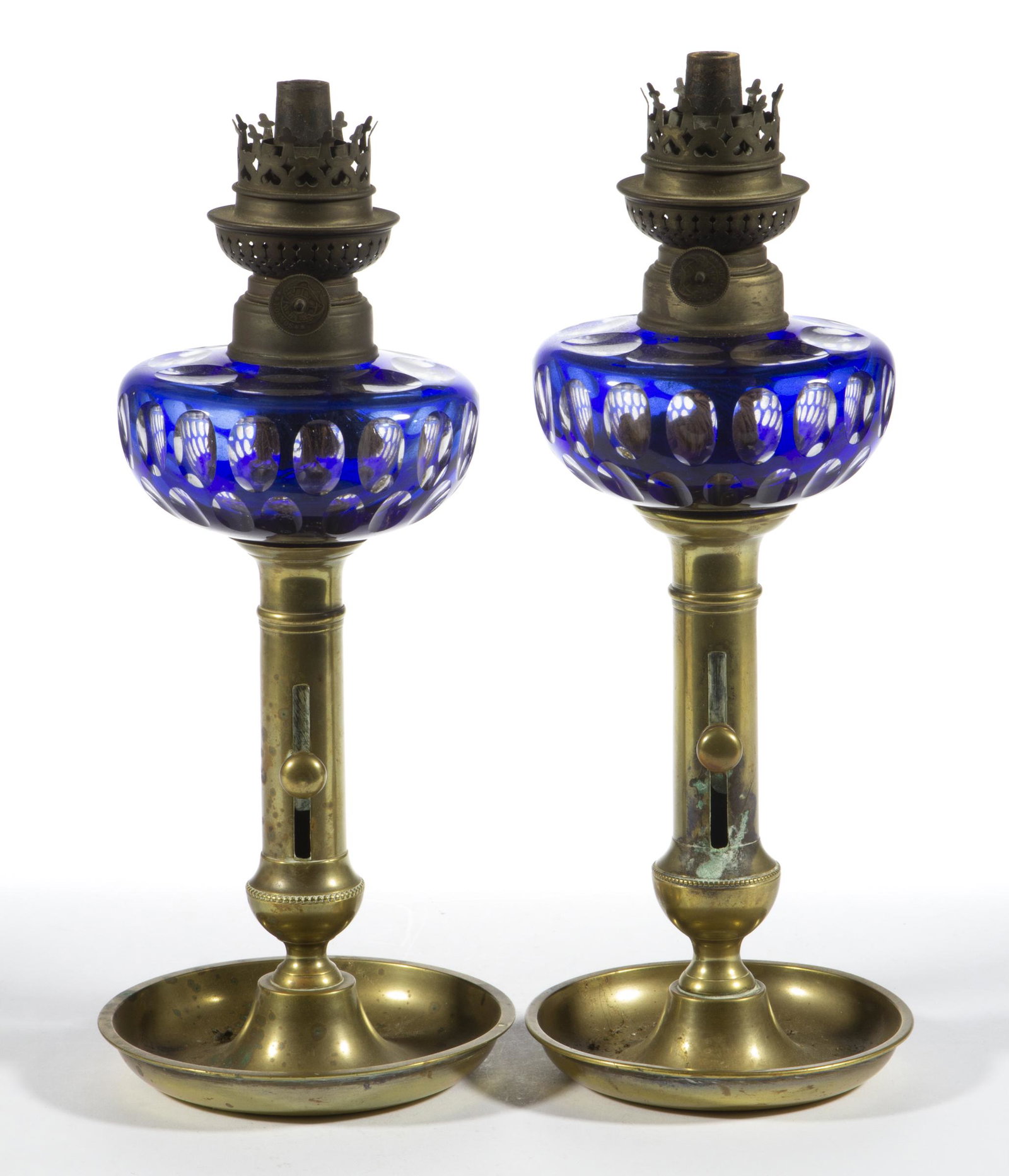 EUROPEAN CUT-OVERLAY GLASS PAIR OF KEROSENE PEG LAMPS,: EUROPEAN CUT-OVERLAY GLASS PAIR OF KEROSENE PEG LAMPS,, cobalt blue to colorless, each having a hemispherical font with two rows of oval cuts with an additional row to the top of the shoulder, each fi
