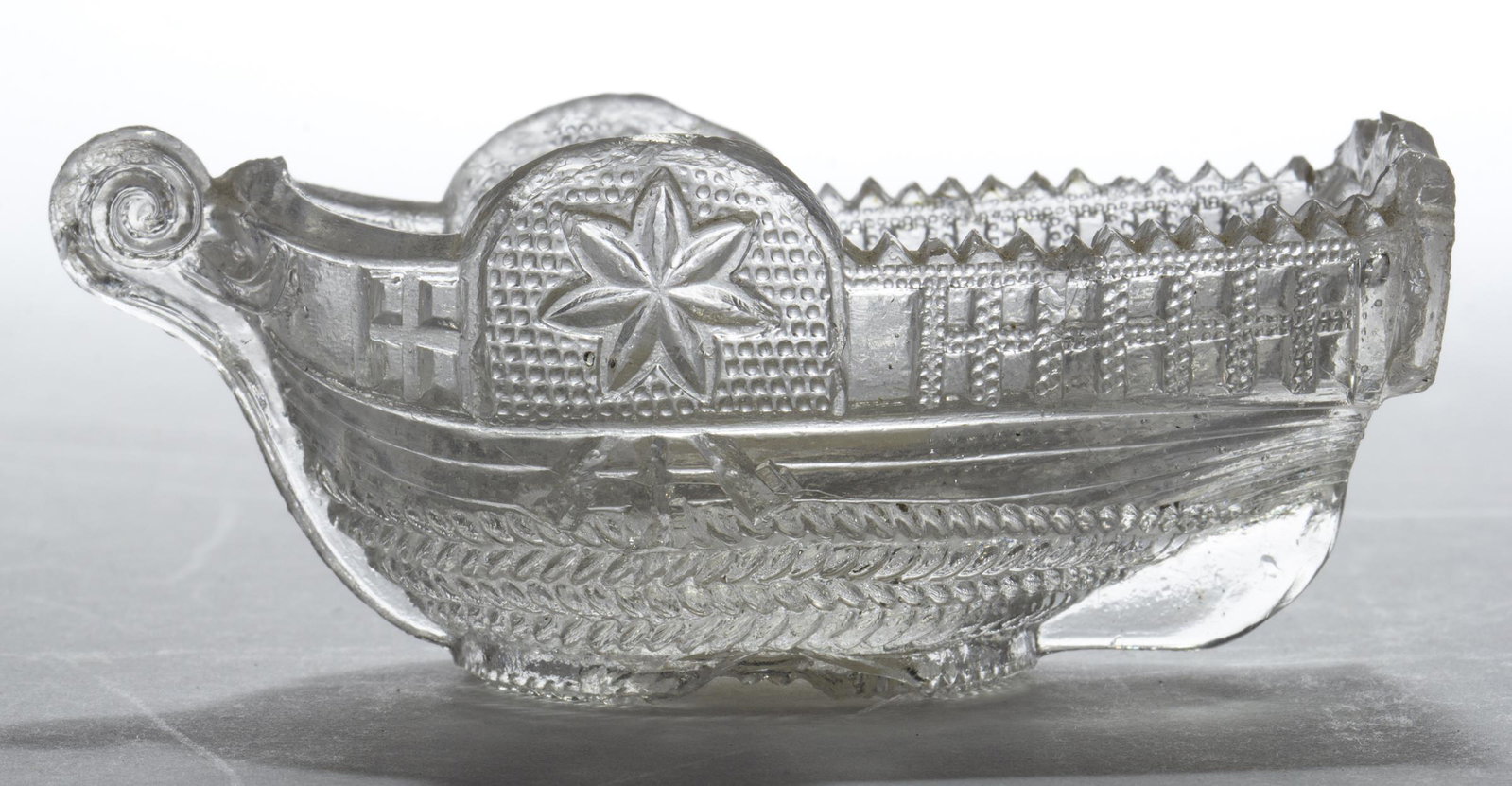 BT-2 "PITTSBURGH." STEAMBOAT PRESSED OPEN SALT: BT-2 "PITTSBURGH." STEAMBOAT PRESSED OPEN SALT, colorless, embossed on stern, rope table ring. Rare. Attributed to the Stourbridge Flint Glass Works, Pittsburgh, PA. 1830-1845. 1 1/2" H, 1 7/8" x 3 5/
