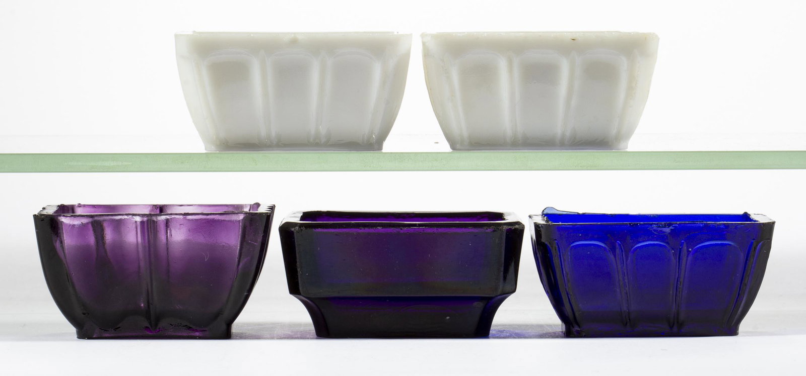 HEAVY OG-SIDE PRESSED OPEN SALTS, LOT OF FIVE: HEAVY OG-SIDE PRESSED OPEN SALTS, LOT OF FIVE, deep amethyst, cobalt blue, and opaque white, including four with a Flute and Prism pattern, each rectangular form with two having a rayed base and three
