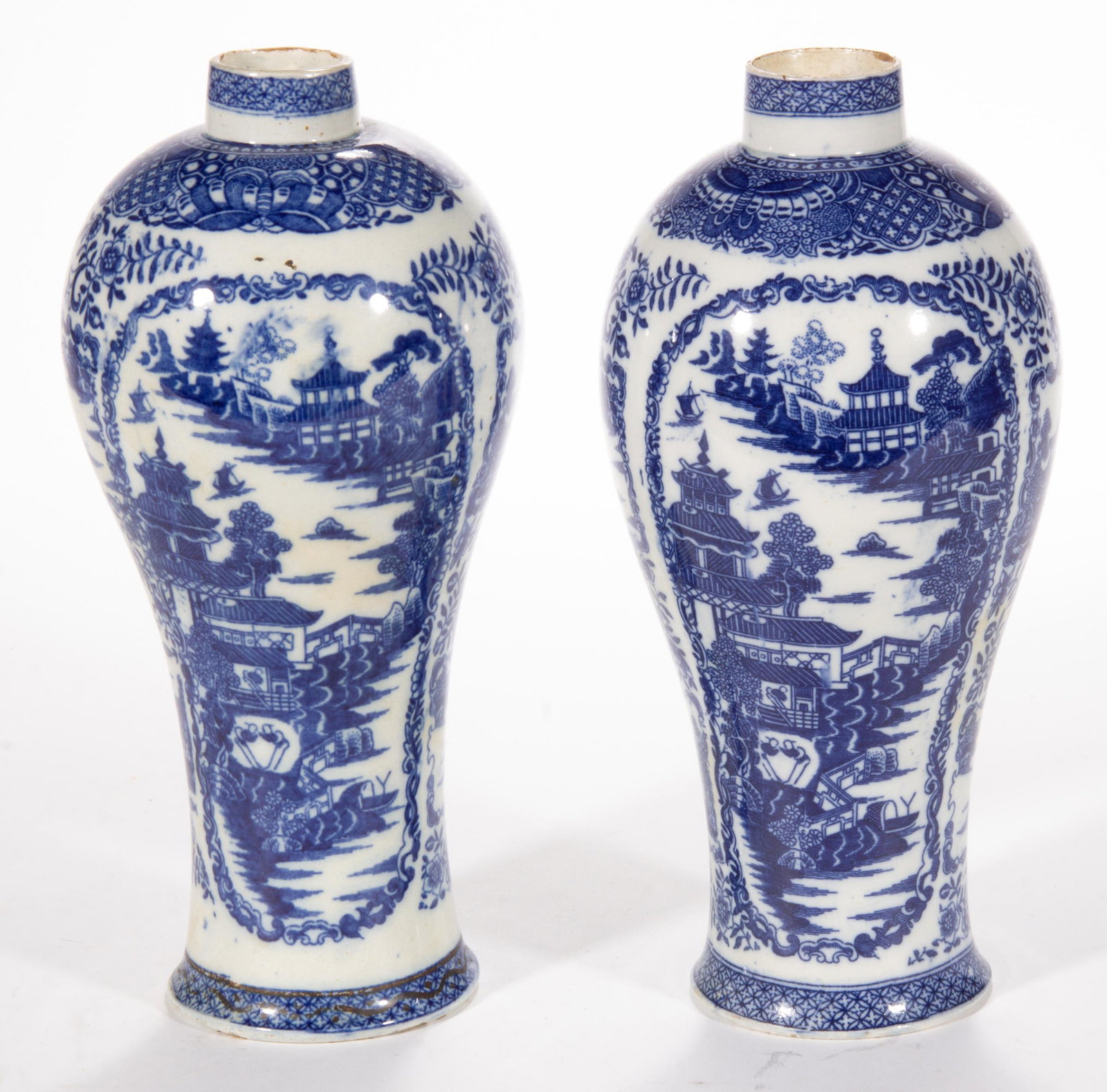 ENGLISH PEARLWARE TRANSFER-PRINTED CHINOISERIE CERAMIC NEAR PAIR OF VASES: ENGLISH PEARLWARE TRANSFER-PRINTED CHINOISERIE CERAMIC NEAR PAIR OF VASES, each of baluster form, featuring blue transfer scene depicting pagodas, boats, and a pair of figures, having butterfly and di