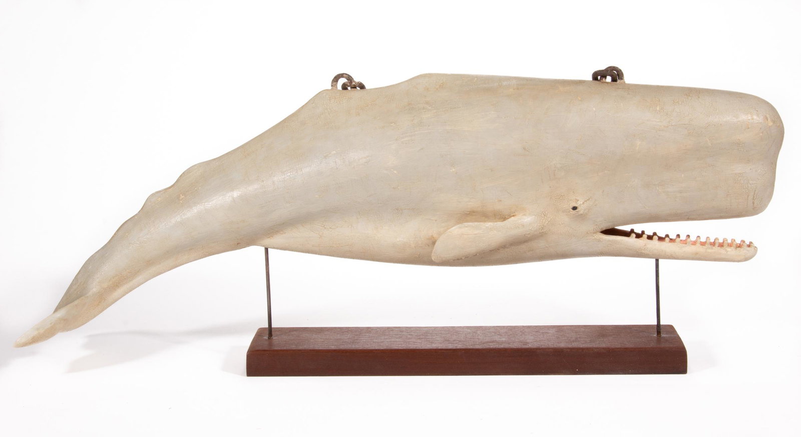 FRANK FINNEY (CAPEVILLE, VIRGINIA, B. 1947) CARVED AND PAINTED FOLK ART FIGURE OF A WHALE: FRANK FINNEY (CAPEVILLE, VIRGINIA, B. 1947) CARVED AND PAINTED FOLK ART FIGURE OF A WHALE, a fine example of large size, finely delineated, with antique wrought-iron link chain hangers and individual