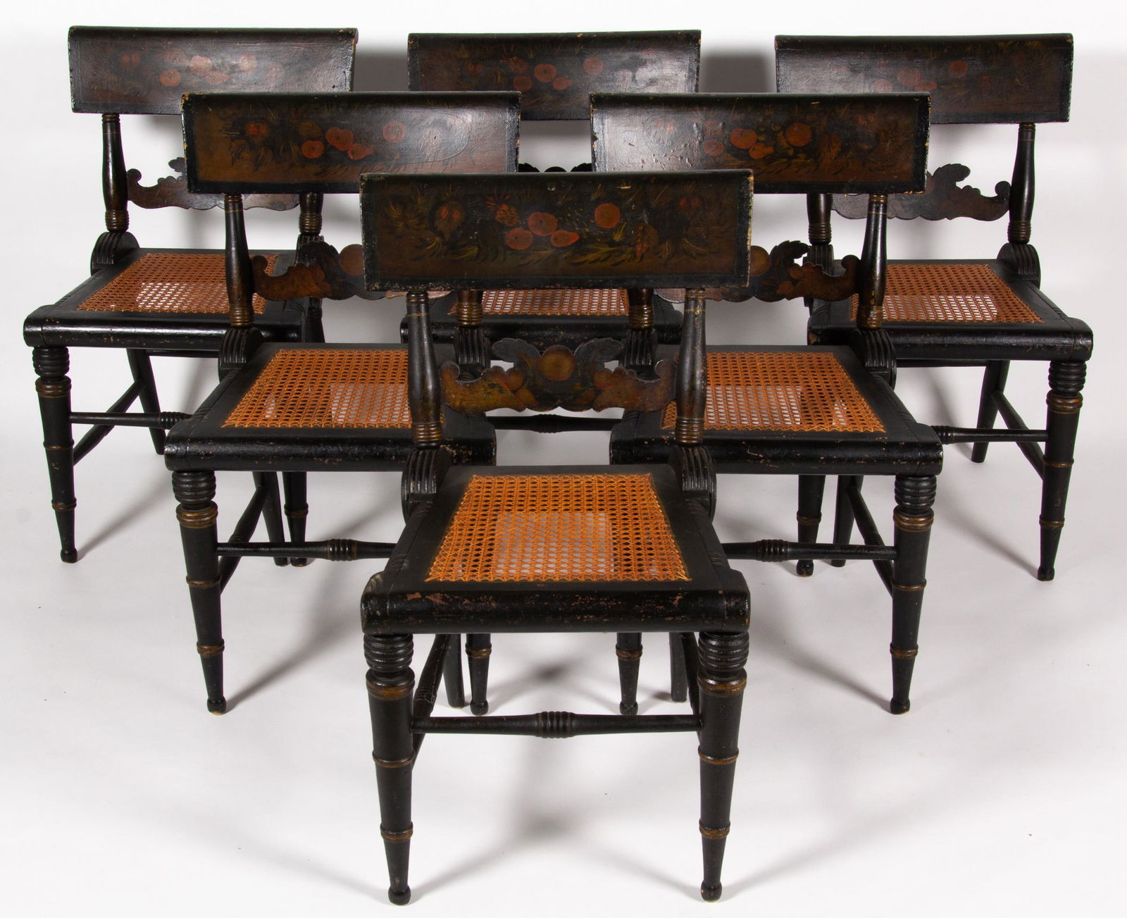 SET OF SIX BALTIMORE, MARYLAND PAINT-DECORATED FANCY CHAIRS: SET OF SIX BALTIMORE, MARYLAND PAINT-DECORATED FANCY CHAIRS, each wheel-back form with tablet crest rail, elaborately shaped stay rail, caned trapezoidal seat, and ring-turned legs joined with box str