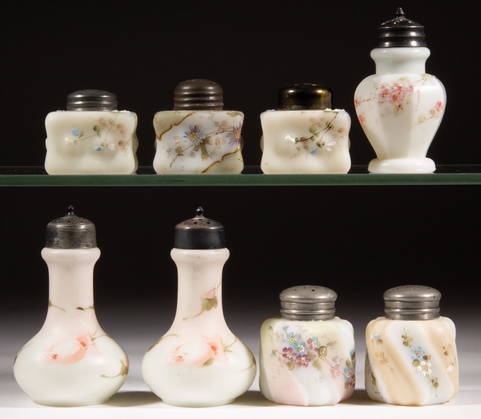 WAVE CREST DECORATED GLASS SALT AND PEPPER SHAKERS, LOT OF EIGHT,: WAVE CREST DECORATED GLASS SALT AND PEPPER SHAKERS, LOT OF EIGHT, opaque white with polychrome-enamel decoration, including three Billows and two Eerie Twists, each having a period lid. C. F. Monroe C