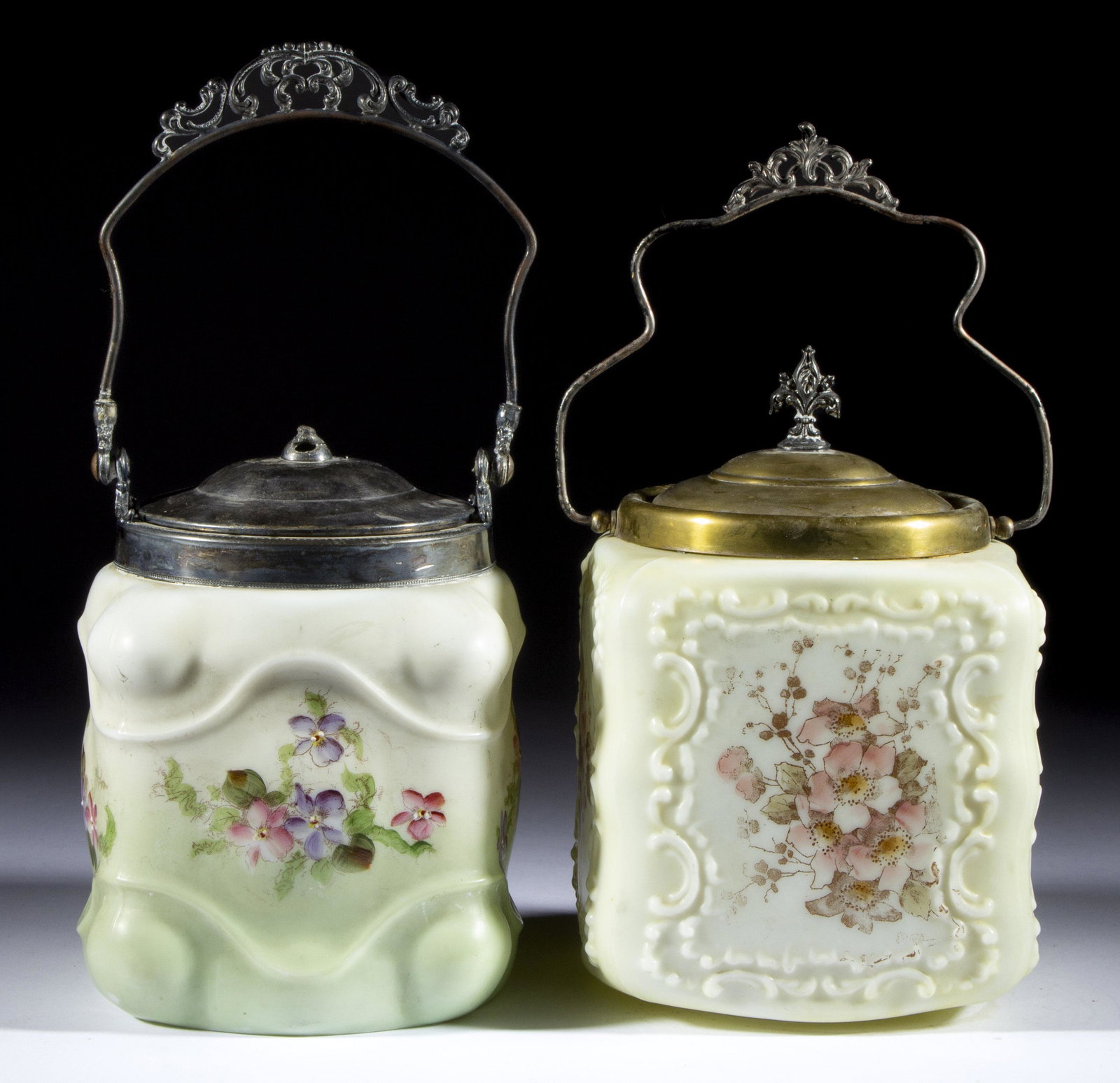ASSORTED DECORATED OPAL GLASS BISCUIT / CRACKER JARS, LOT OF TWO,: ASSORTED DECORATED OPAL GLASS BISCUIT / CRACKER JARS, LOT OF TWO, opaque white with polychrome-enamel decoration, comprising a Wave Crest Embossed Scroll and an unidentified Scrolling example, each ha