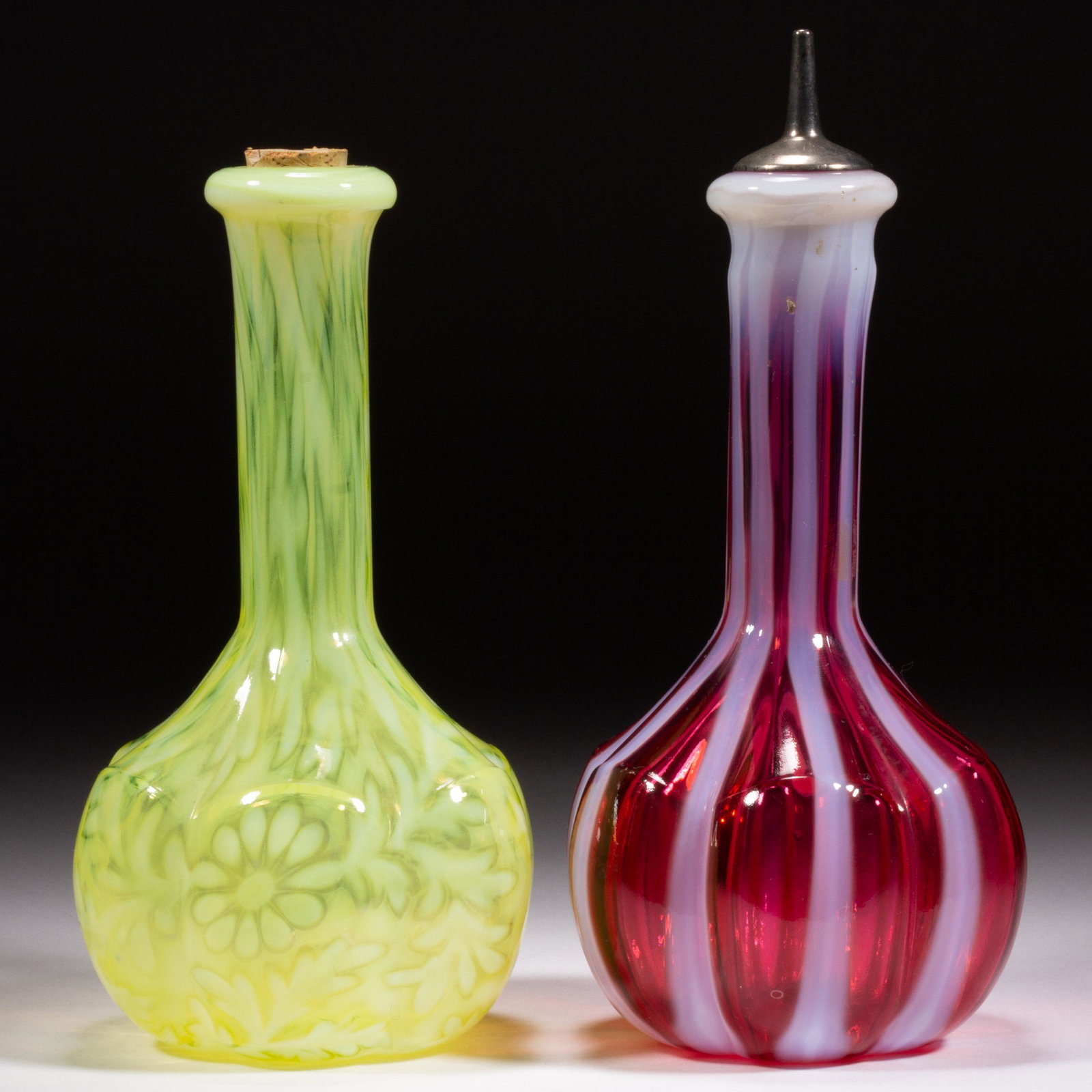 L. G. WRIGHT OPALESENT BITTERS / BARBER'S BOTTLES, LOT OF TWO,: L. G. WRIGHT OPALESENT BITTERS / BARBER'S BOTTLES, LOT OF TWO, comprising a cranberry opalescent Stripe with a period spout, and a Vaseline opalescent (reacts under black light) with interior cork, la