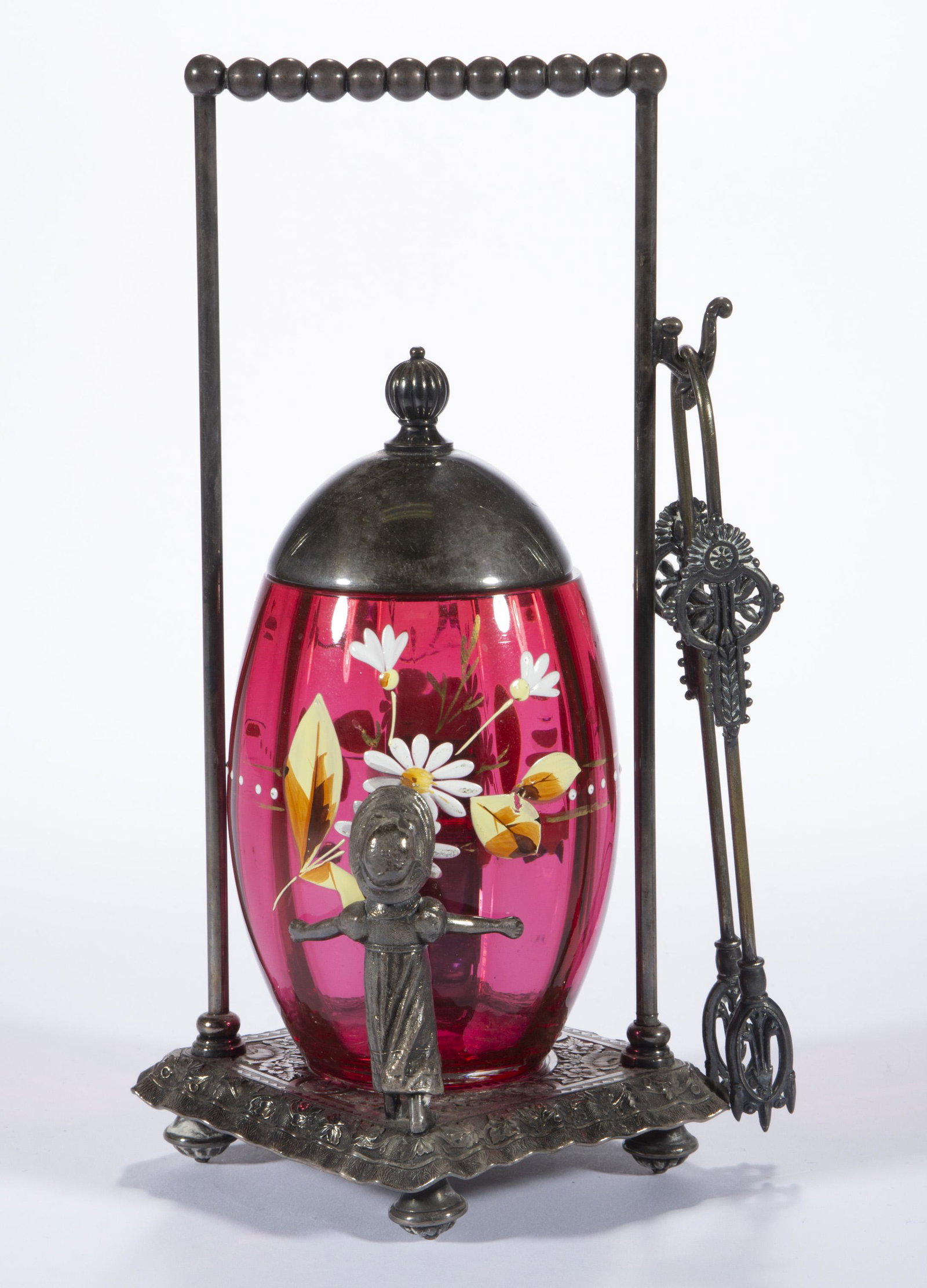 VICTORIAN PANEL-OPTIC AND ENAMEL DECORATED PICKLE CASTER,: VICTORIAN PANEL-OPTIC AND ENAMEL DECORATED PICKLE CASTER, cased cranberry with polychrome-enamel decoration, ovoid insert with floral decoration, fitted into a quadruple-plate stand depicting two chil