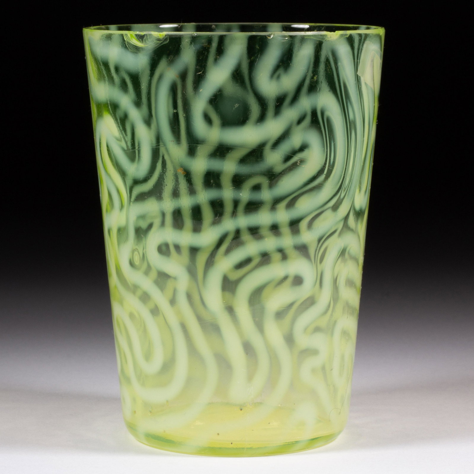 SWIRLING MAZE TUMBLER,: SWIRLING MAZE TUMBLER, Vaseline opalescent (reacts under black light), factory-polished rim. Jefferson Glass Co. Circa 1905. 4" H.Literature: Parallels Heacock/Elmore - Opalescent Glass From A to Z, p