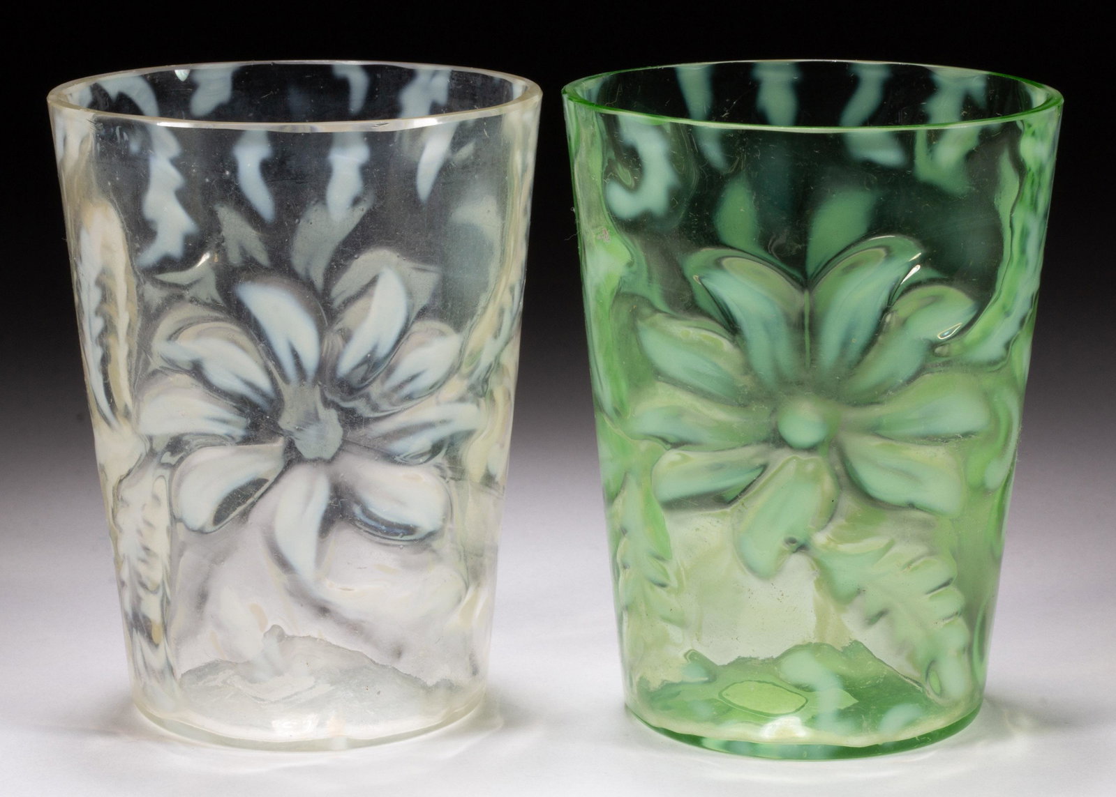 POINSETTIA TUMBLERS, LOT OF TWO,: POINSETTIA TUMBLERS, LOT OF TWO, colorless opalescent and green opalescent. Northwood Glass Co. Circa 1903. 3 7/8" H. Literature: Parallels Heacock/Elmore - Opalescent Glass From A-Z, p. 128, fig. 266