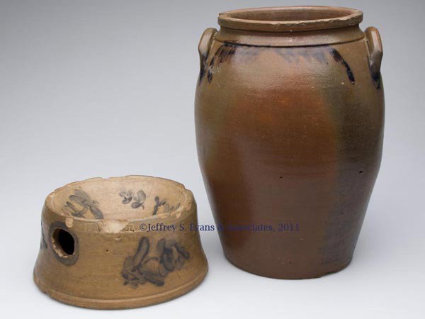 TWO UNIDENTIFIED AMERICAN DECORATED POTTERY ARTICLE: TWO UNIDENTIFIED AMERICAN DECORATED POTTERY ARTICLES, salt glazed, comprising a stoneware spittoon with a mark mostly obscured by a chip, and an earthenware two-gallon ovoid jar with two handles. Jar 