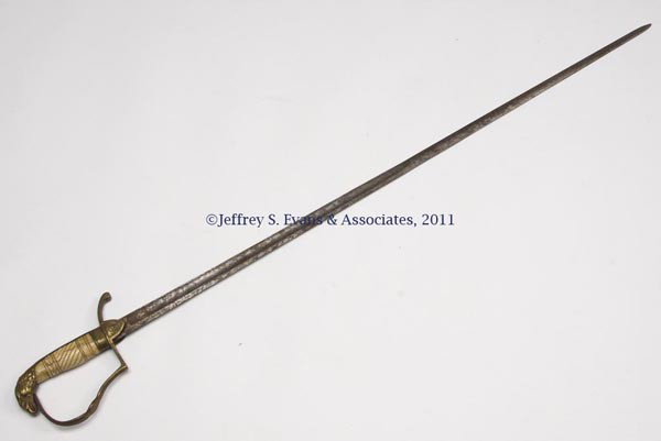 EAGLE-HEAD MILITIA SWORD: EAGLE-HEAD MILITIA SWORD, gilt-brass guard, pommel and hilt, carved bone/ivory grip, etched blade with cannons, drum and flags, and wreath and torch, no name visible. First half 19th century. 34 1/4" 