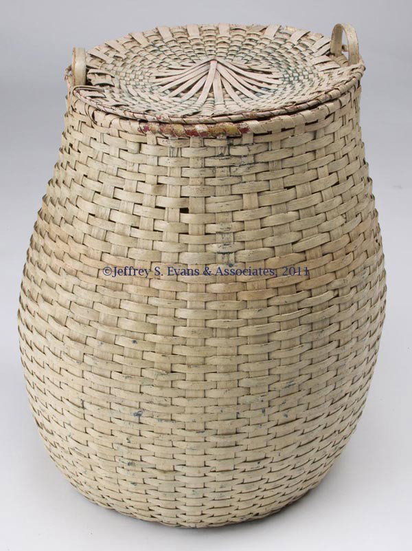 NEW ENGLAND ASH SPLINT FEATHER BASKET: NEW ENGLAND ASH SPLINT FEATHER BASKET, large ovoid form with two arched side handles with carved rim notches and a kick-up bottom, original cover with cut-outs to fit over handles. Old white paint ove