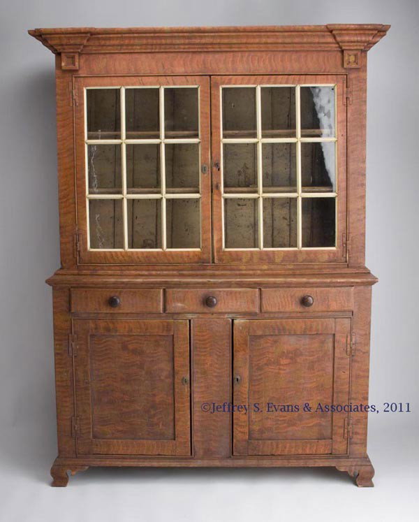 PENNSYLVANIA PAINT-DECORATED STEP-BACK CUPBOARD: PENNSYLVANIA PAINT-DECORATED STEP-BACK CUPBOARD, pine and poplar, in two sections. The top with a bold stepped cornice above two nine-pane glazed doors concealing two fixed shelves, each with spoon sl