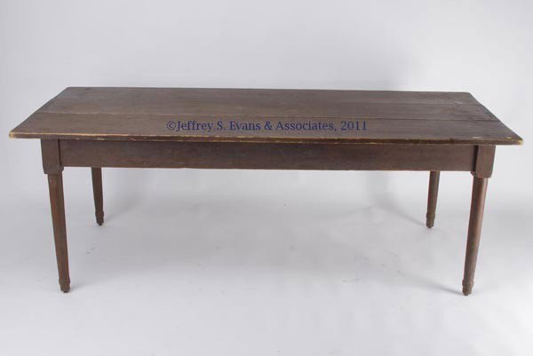 MID-ATLANTIC VERNACULAR PAINTED FARM TABLE: MID-ATLANTIC VERNACULAR PAINTED FARM TABLE, mixed woods, three-board top raised on simple turned legs. Retains an old dry Spanish-brown painted surface. Mid 19th century. 29" H, 36" x 82 1/2" top.