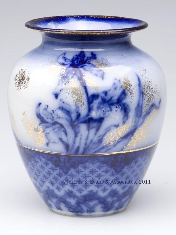 ENGLISH STAFFORDSHIRE TRANSFERWARE FLOW BLUE VASE: ENGLISH STAFFORDSHIRE TRANSFERWARE FLOW BLUE VASE, gilt decoration, iris spray obverse and reverse above diapering on the lower half, base with trademark and "ENGLAND". Edge, Malkin & Co., Burslem, En