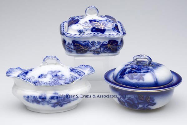ENGLISH STAFFORDSHIRE TRANSFERWARE FLOW BLUE SOAP: ENGLISH STAFFORDSHIRE TRANSFERWARE FLOW BLUE SOAP BOXES, LOT OF THREE, two with gilt decoration, comprising an oval example with drainer, marked "HARLEY /FB" and "ENGLAND" on base; a round example wit