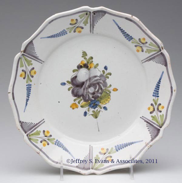 TIN-GLAZED FAIENCE PLATE: TIN-GLAZED FAIENCE PLATE, polychrome floral decoration, underglaze "B" on reverse. Probably France. Probably 19th century. 8 7/8" D.