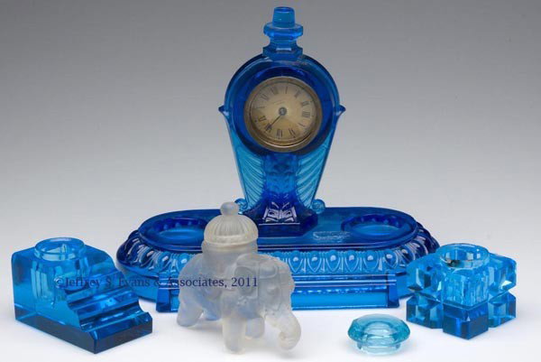 PRESSED AND OTHER GLASS DESK ACCESSORIES, LOT OF F: PRESSED AND OTHER GLASS DESK ACCESSORIES, LOT OF FOUR, colorless with frosted finish, and blue, comprising a clock on stand with pen holder and recesses for ink bottles, back of clock stamped "THE PAR