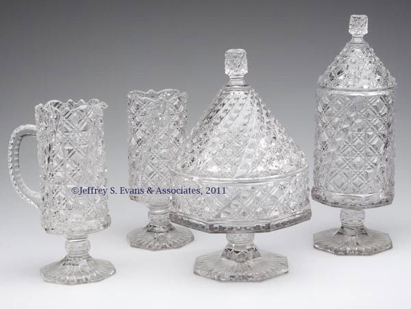 MCKEE'S COMET FOUR-PIECE TABLE SET: MCKEE'S COMET FOUR-PIECE TABLE SET, colorless, comprising a covered butter dish, covered sugar bowl, creamer, and a spooner. McKee & Brothers. Fourth quarter 19th century. 7 3/8" to 11" HOA.