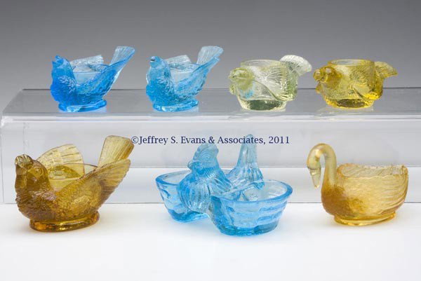 VARIOUS FIGURAL SALTS, LOT OF SEVEN: VARIOUS FIGURAL SALTS, LOT OF SEVEN, various colors, including a bird, a bird with berry, a swan, and a hen with double basket. 19th and 20th centuries. Various sizes. Provenance: From the collection 