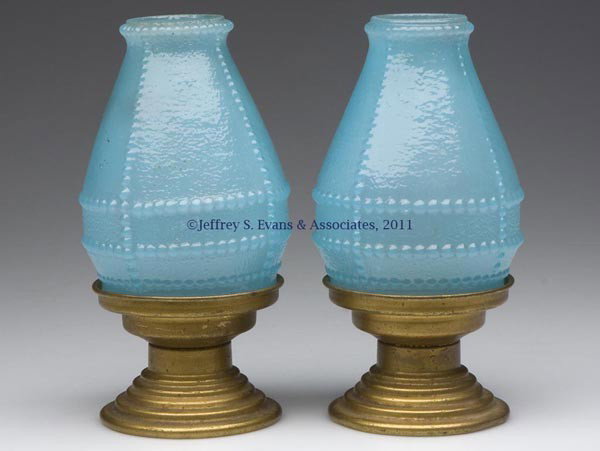 DIAMOND CANDLE CO. PAIR OF CANDLE LAMPS: DIAMOND CANDLE CO. PAIR OF CANDLE LAMPS, textured robin's egg blue, with horizontal and vertical beaded decoration, each on a stamped gilded brass base. The fitter of each shade and the candle cup of 