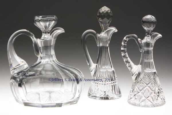AMERICAN CUT GLASS ARTICLES, LOT OF THREE: AMERICAN CUT GLASS ARTICLES, LOT OF THREE, colorless, comprising a panel-cut ship's decanter, star under base and matching stopper; a Pairpoint #523 cruet featuring prisms and cubes, panel-cut neck, s