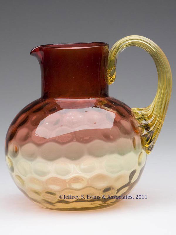 AMBERINA HONEYCOMB-OPTIC PITCHER: AMBERINA HONEYCOMB-OPTIC PITCHER, amber applied reeded handle, polished pontil mark. Late 19th/early 20th century. 5 3/8" H.