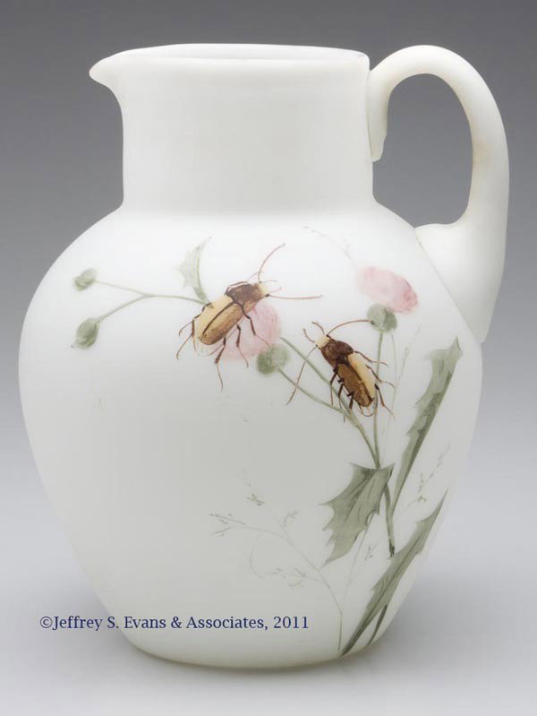 VICTORIAN DECORATED WATER PITCHER: VICTORIAN DECORATED WATER PITCHER, opal with satin finish and floral and beetle polychrome decoration, opal applied handle with pressed feather design to upper terminal, polished pontil mark. Late 19t