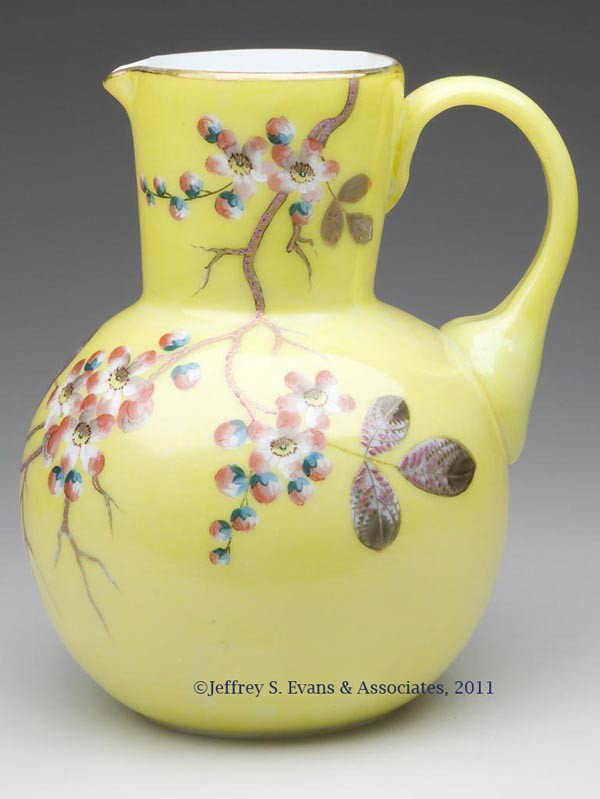 VICTORIAN DECORATED WATER PITCHER: VICTORIAN DECORATED WATER PITCHER, opal with painted yellow ground, floral polychrome and gilt decoration, ball form body, matching color applied handle, polished pontil mark. Late 19th/early 20th cen
