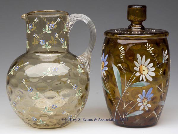 VICTORIAN ENAMEL-DECORATED DOT-OPTIC ARTICLES, LOT: VICTORIAN ENAMEL-DECORATED DOT-OPTIC ARTICLES, LOT OF TWO, comprising a dark amber covered jar and a light amber water pitcher with colorless applied reeded handle and polished pontil mark, each with 