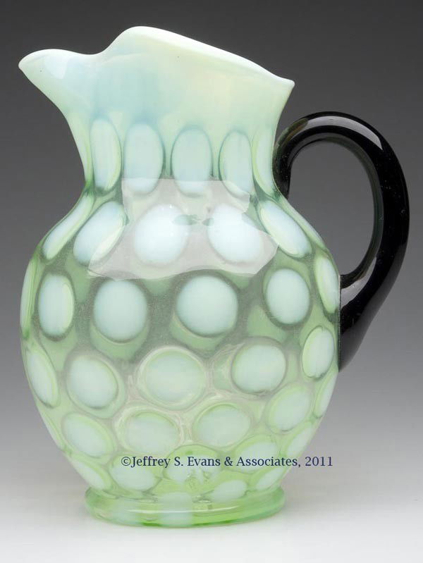 FENTON'S NO. 1352 DOT OPTIC WATER PITCHER: FENTON'S NO. 1352 DOT OPTIC WATER PITCHER, lime opalescent, ice lip rim, black applied handle. Fenton Art Glass. Second quarter 20th century. 9 1/4" HOA. Literature: Fenton II, fig. 427.