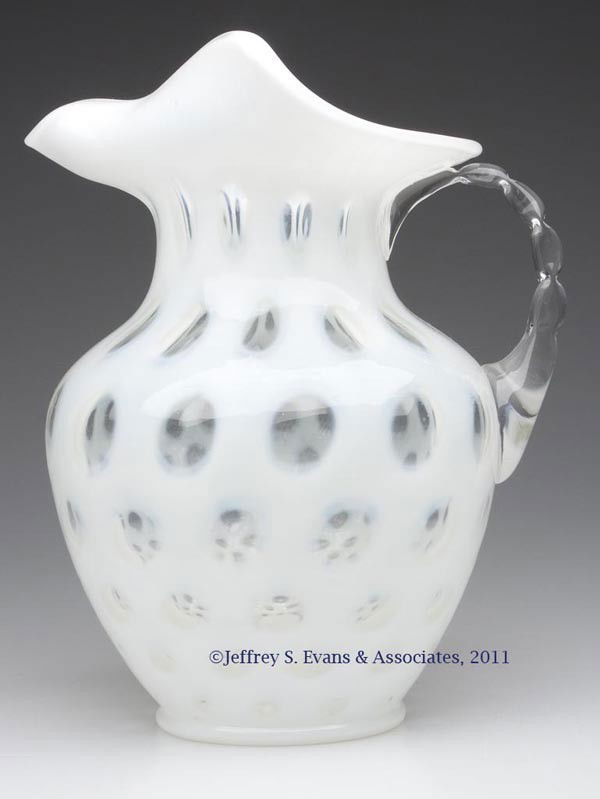 FENTON'S NO. 1353 COIN DOT WATER PITCHER: FENTON'S NO. 1353 COIN DOT WATER PITCHER, French/colorless opalescent, ice lip rim, colorless applied pinched handle. Fenton Art Glass. Mid 20th century. 9 1/4" HOA.