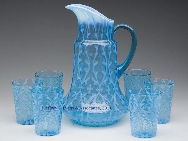 OPALINE BROCADE / SPANISH LACE SEVEN-PIECE WATER S: OPALINE BROCADE / SPANISH LACE SEVEN-PIECE WATER SET, blue opalescent, comprising an eight-panel mold tankard pitcher, transparent blue applied handle; and six tumblers. Late 19th/early 20th century.