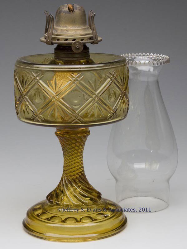 UNNAMED PATTERN STAND LAMP: UNNAMED PATTERN STAND LAMP, amber, crossbars with dots patterned font and swirled rib stem, No. 2 Taplin-Brown collar, period slip burner and chimney. Fourth quarter 19th century. 9 1/4" H to top of c