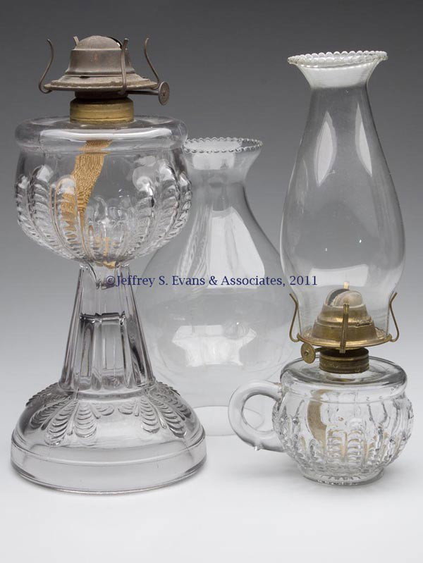 TURKEY FOOT FINGER AND STAND LAMPS, LOT OF TWO: TURKEY FOOT FINGER AND STAND LAMPS, LOT OF TWO, colorless, No. 1 and No. 2 Taplin-Brown collars, period slip burners and chimneys, including a big bulge with traces of Torch and Wreath etched decorati