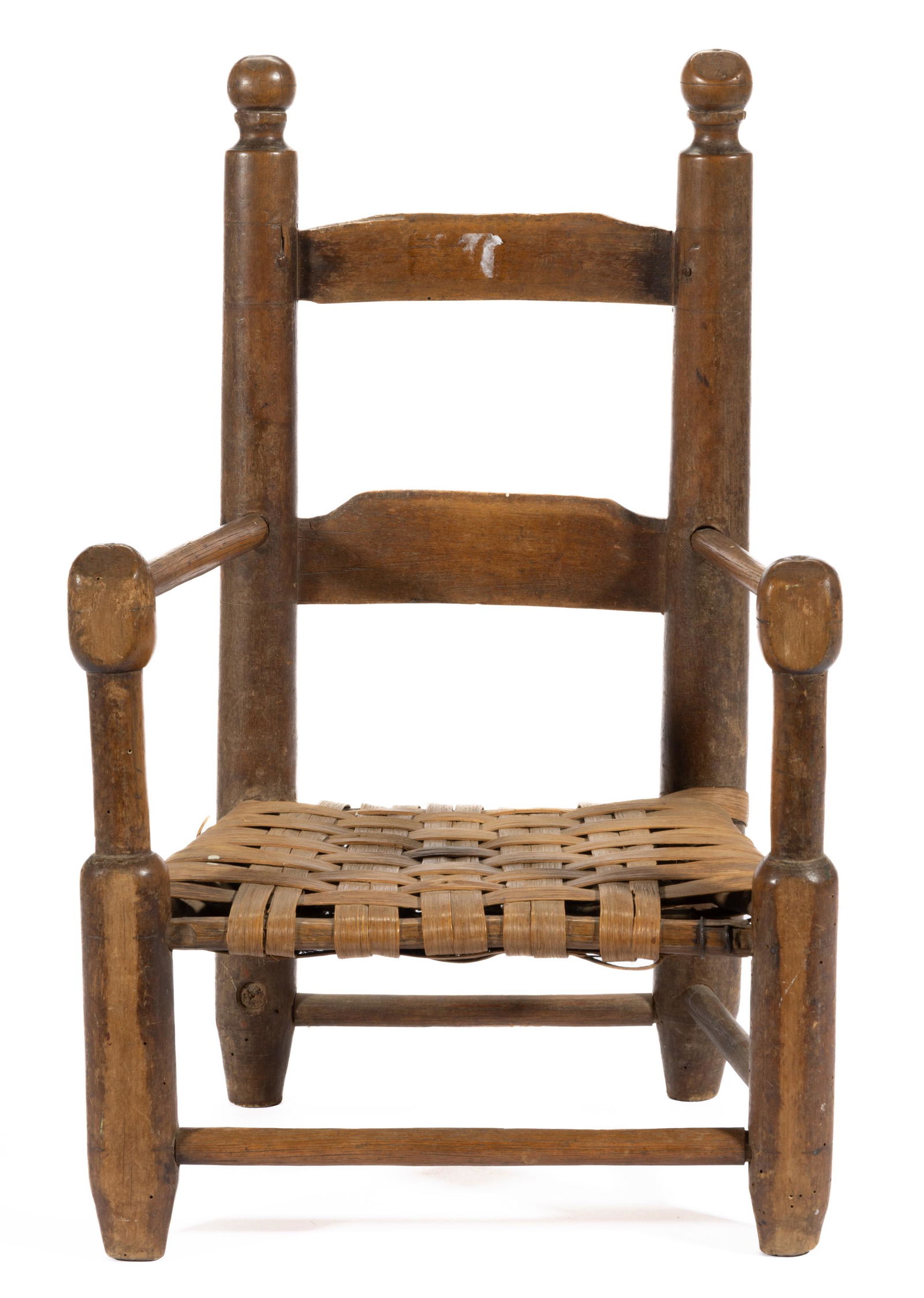 NORTH CAROLINA TURNED LADDERBACK SPLIT-BOTTOM CHILD'S CHAIR,: maple and oak, with two-slat back, boldly turned finials and front posts, woven-splint seat, and box stretcher. Old natural surface. Possibly Mecklenburg Co., NC area. Early 19th century. 22" HOA, 9 1