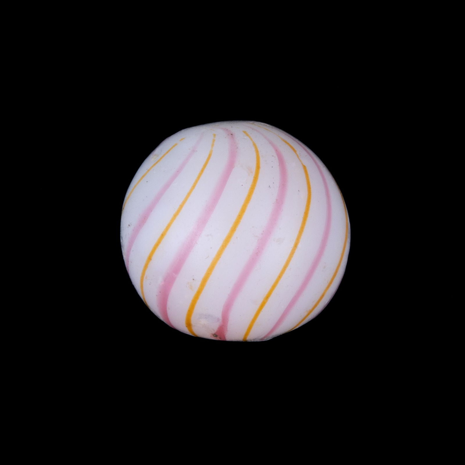 RARE ANTIQUE PINK AND YELLOW BANDED CLAMBROTH MARBLE,: white base with alternating bands of pink and yellow. Late 19th/early 20th century. 11/16" D.Provenance: From the Eddie Tatum estate collection, Winston-Salem, NC.